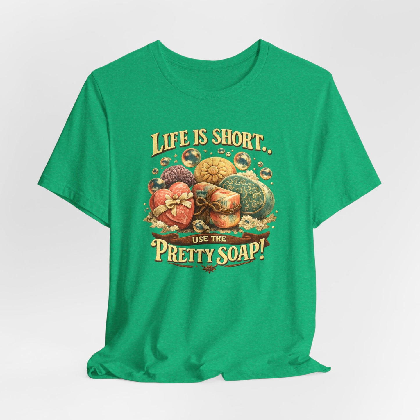 Green T-shirt displays "Life is Short, Use the Pretty Soap!" graphic with decorative soaps and bubbles.
