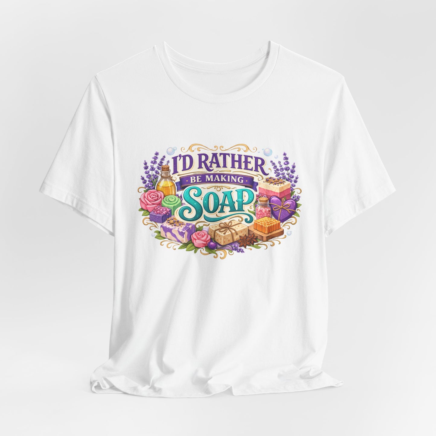 White t-shirt with colorful graphic and text 'I'd Rather Be Making Soap' on a white background