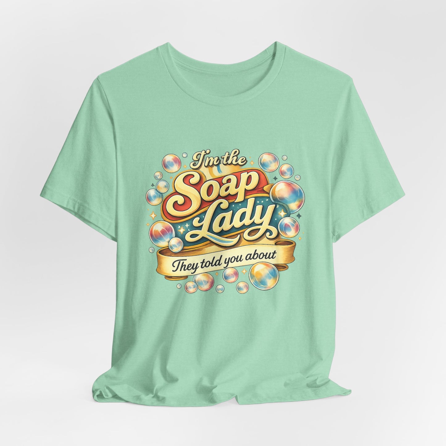 Mint green t-shirt with colorful 'I'm the Soap Lady' graphic design on a light gray background