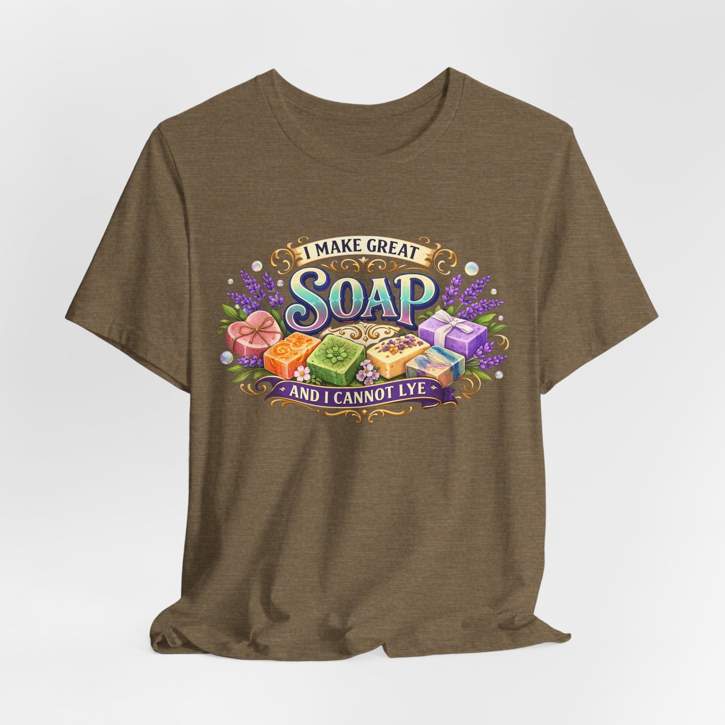 A brown t-shirt displays a colorful graphic stating, "I Make Great Soap and I Cannot Lye" with illustrations of handmade soaps and lavender.
