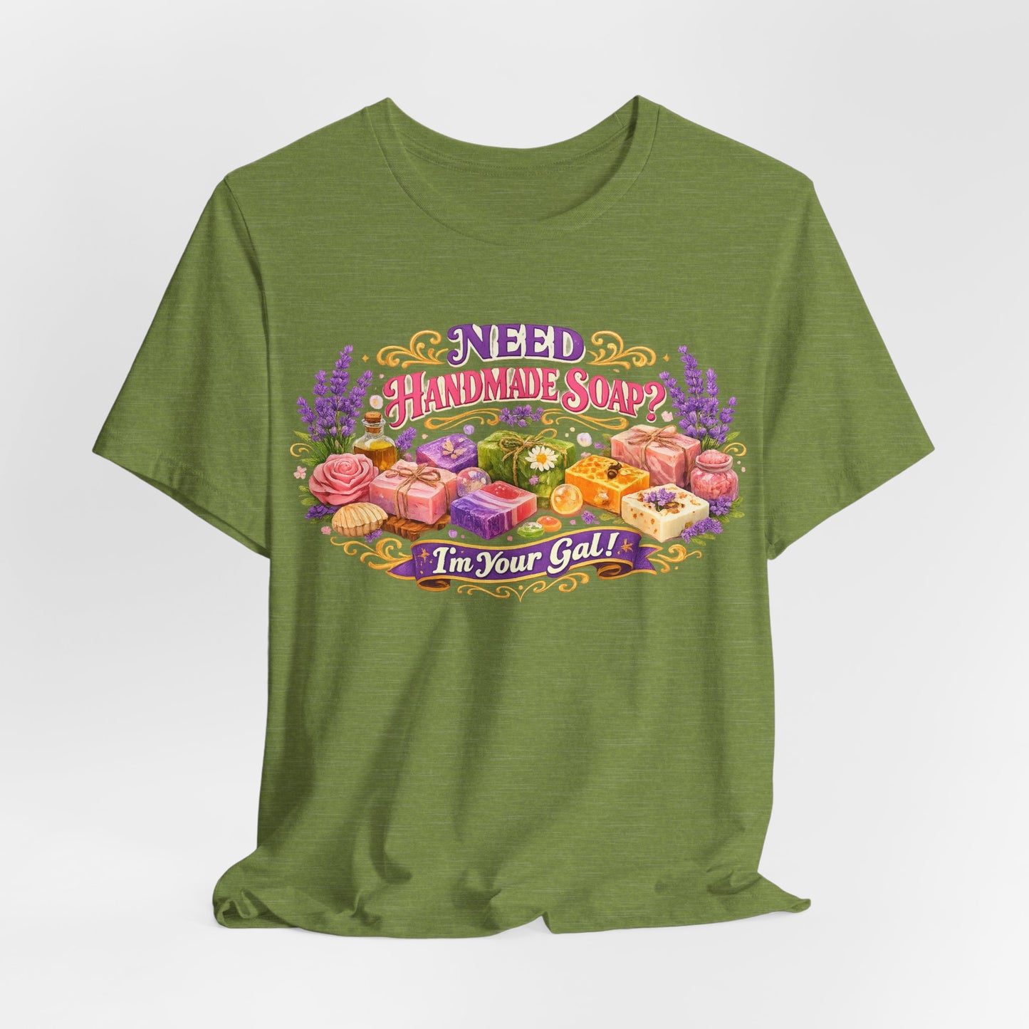 Olive green t-shirt displays a floral graphic that asks "Need Handmade Soap?" and declares "I'm Your Gal!".
