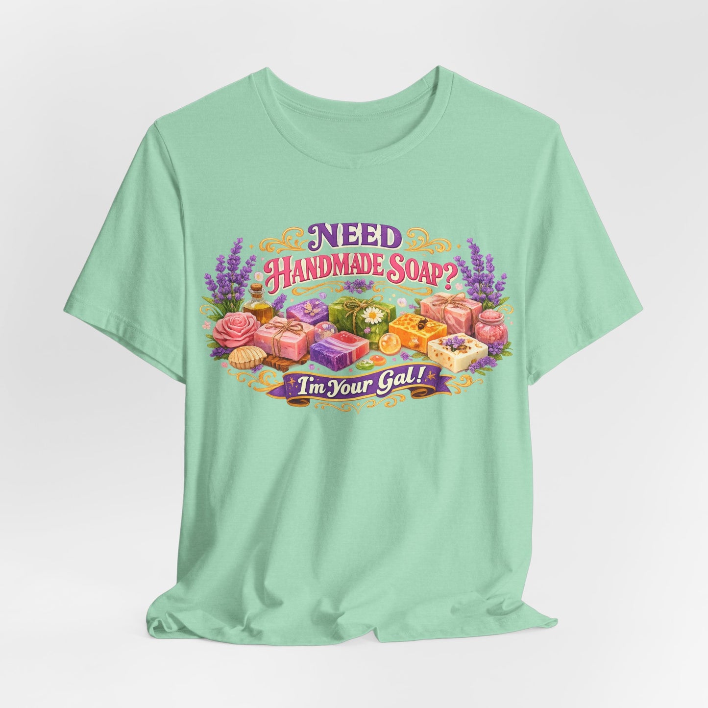 Mint t-shirt features a vibrant design promoting handmade soap with the playful message "Need Handmade Soap? I'm Your Gal!".

