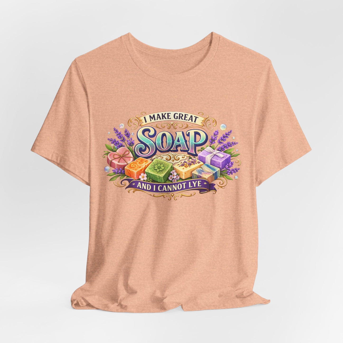 Peach t-shirt displays a graphic saying "I Make Great Soap And I Cannot Lye" surrounded by colorful handcrafted soaps and lavender.
