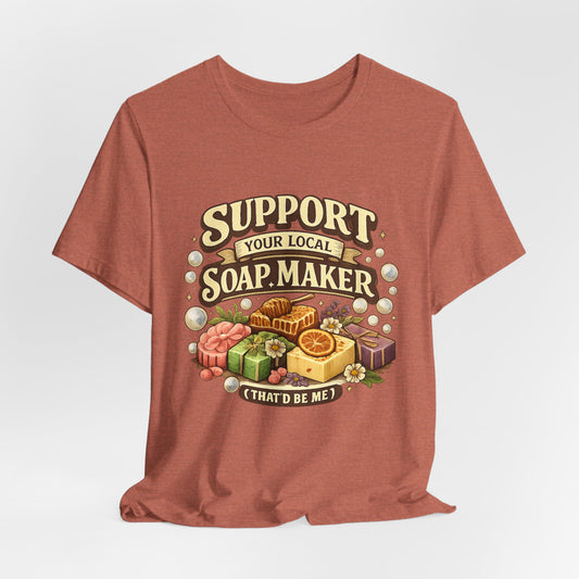 Brown t-shirt with soap-themed graphic that says support your local soap maker on a white background
