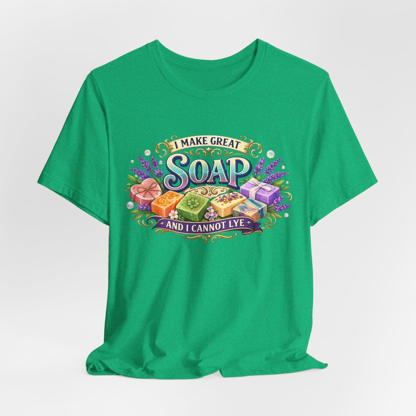 Displaying a green t-shirt showcasing a whimsical design with assorted artisanal soaps and the text "I Make Great Soap and I Cannot Lye."
